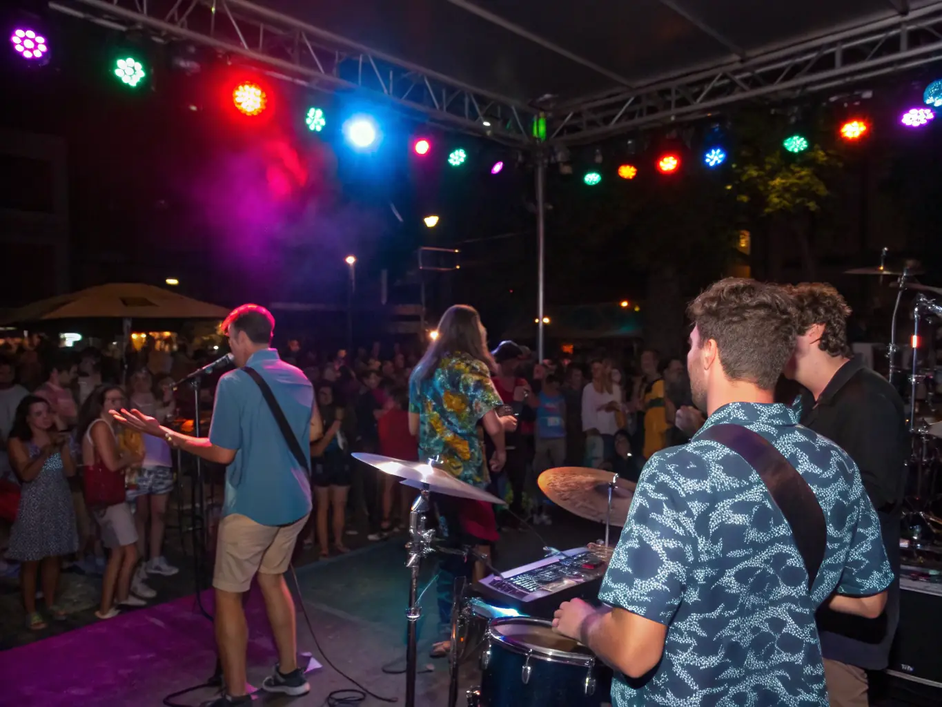 An image of a lively concert with an engaged audience, stage lighting, and performers in action, capturing the energy and community spirit of HIGHNOON's events.