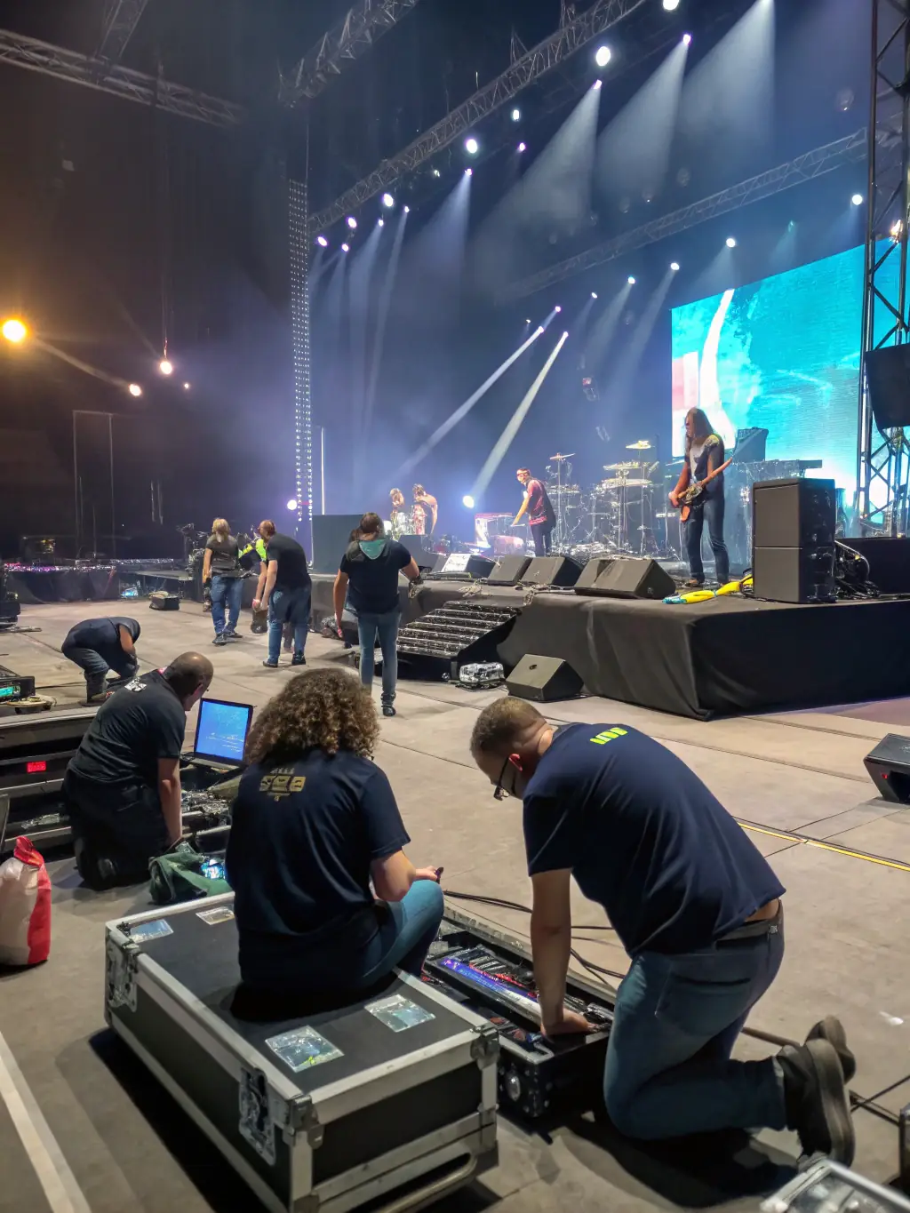 A picture of volunteers setting up for a community music festival organized by HIGHNOON, highlighting the collaborative effort and community spirit behind the event.